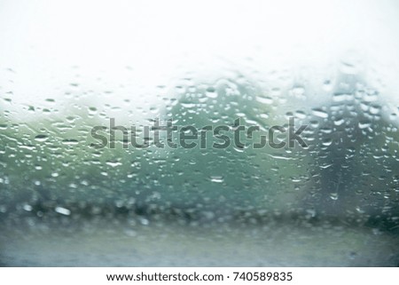 drops on the window with the background of the city lights