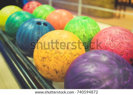 Colorful bowling balls in return machine