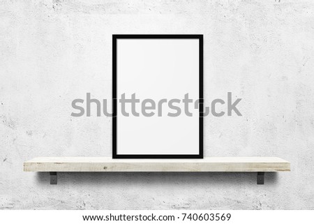White blank photo frame mockup on shelf over white concrete wall background