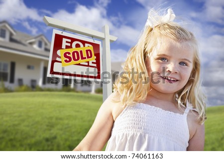 Cute Smiling Girl in Front Yard with Sold For Sale Real Estate Sign and House.