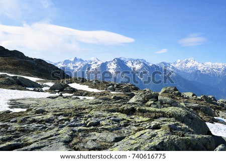 View of beautiful landscape in the Alps with snow-capped mountain tops.