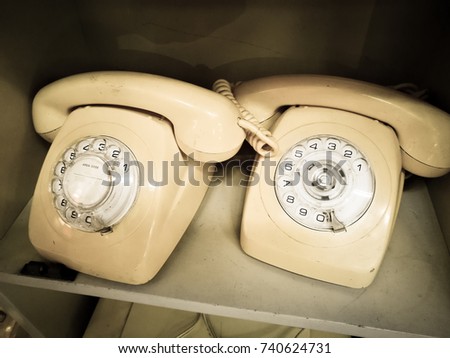 White cream Vintage Rotary desk Telephone in Aged tone photo.