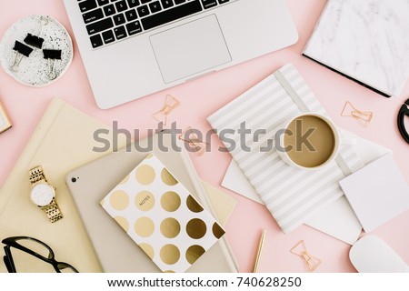 Modern office desk workspace with laptop, notebook and stationery on pastel pink background. Top view. Flat lay lifestyle workspace header.