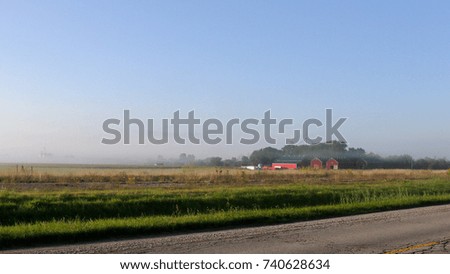 Rural landscape with barns trees and wind turbines in Southern Ontario
