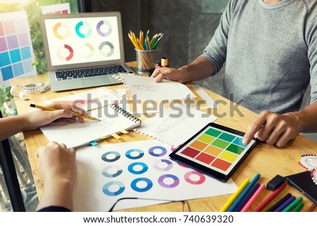 young fashion designer work with fabric cloth on the wood table or graphic designer vintage tone