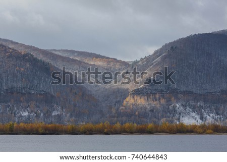Dramatic landscape on the Volga river. Mountains in morning fog. National park near river. Soft light touches mountains.