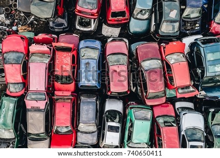 Old rusty corroded cars in car scrapyard. Car recycling Royalty-Free Stock Photo #740650411