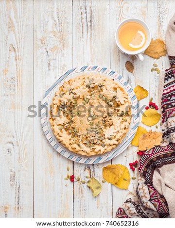 Autumn background with pumpkin pie, hot tea, yellowed leaves, book and rug. Perfect sunny autumn. A wooden light white autumn background for you.
Copy Space. Place for text. Flat lay, top view