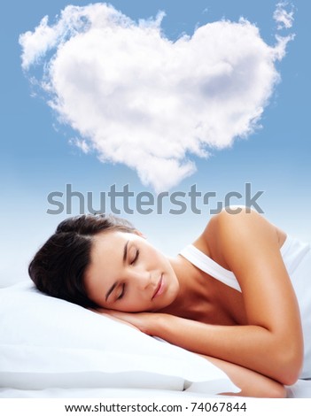 Portrait of a young girl sleeping on a pillow with heartshaped cloud over her Royalty-Free Stock Photo #74067844