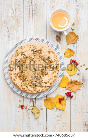 Autumn background with pumpkin pie, hot tea, yellowed leaves, book and rug. Perfect sunny autumn. A wooden light white autumn background for you.
Copy Space. Place for text. Flat lay, top view