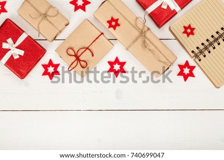 frame made of homemade wrapped christmas and new year present boxes and decoration on wooden background with copy space for text. holiday and celebration concept. above view, flat lay.