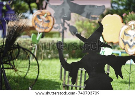 Black paper witch in the garden of Halloween party.