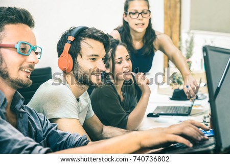 Group of young people employee workers with computer in startup studio - Human resource business and teamwork concept on laptop working time - Start up entrepreneurs at office - Teal and orange filter Royalty-Free Stock Photo #740736802