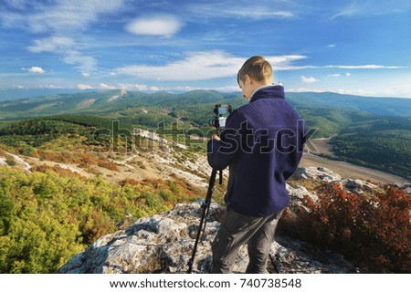 Photographer work in mountain. Job scene.