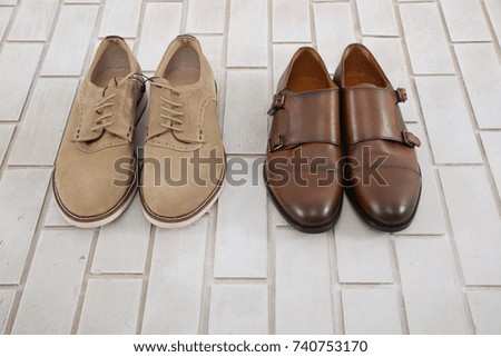Set of mans fashion leather shoes on white brick wall