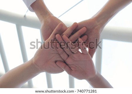 Meeting teamwork concept,Friendship,Group people with stack of hands showing unity on city background