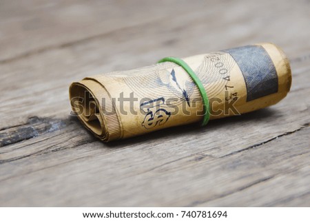 A roll of old banknotes Over Wooden Background