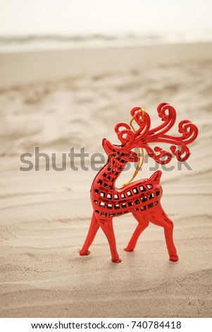 red reindeer christmas decoration on the beach