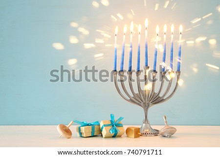 image of jewish holiday Hanukkah background with traditional spinnig top, menorah (traditional candelabra) and burning candles