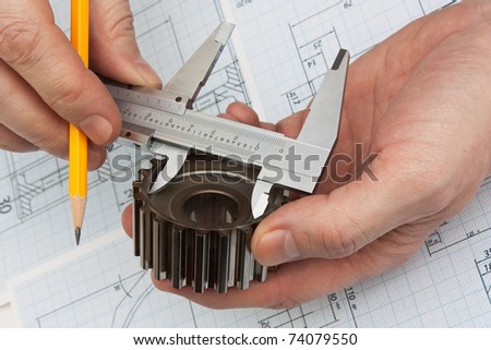 technical drawing and tools in hand Royalty-Free Stock Photo #74079550