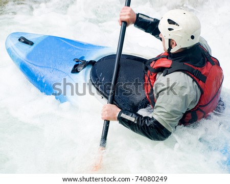 an active kayaker on the rough water