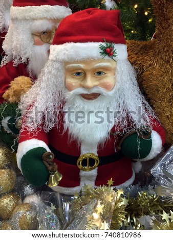 Santa Claus statue with Christmas decoration. Santa to bring presents for children. He is conventionally pictured as a jolly old man with a long white beard and red garments trimmed with white fur.
