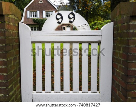 number 99 house number ninety nine on a white wooden fence (99)