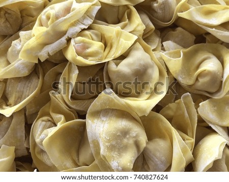Homemade fresh wonton dumplings.The process of cooking dumplings, the square sheets of wheat dough enclosing mince pork or shrimp, boiled in soup stock.