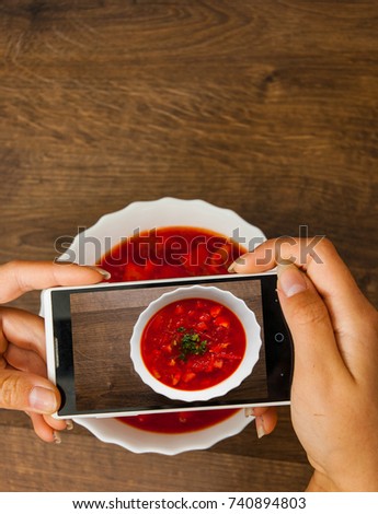 A hands young woman taking photo of food on smartphone, photographing meal with mobile camera. with copy space. top view