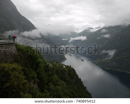 Tourists taking pictures of Geiranger Fjord from Ørnesvingen-eagle Road viewpoint, Norway