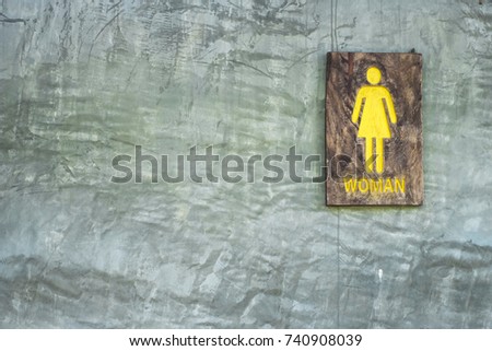 Toilet sign, symbol, made by old wooden paint by yellow color.