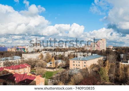 Panorama of a new city under blue sky with huge white clouds