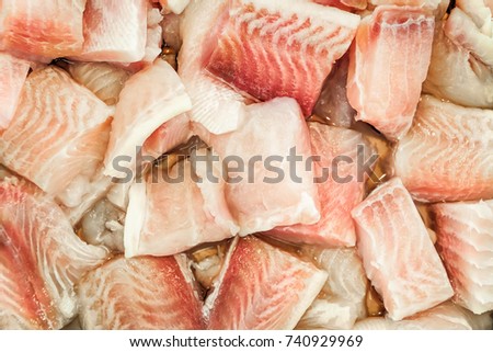 Fresh monkfish fillet on ice for sale at market.
