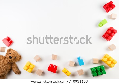 Kids toys background with teddy bear and colorful blocks Royalty-Free Stock Photo #740931103