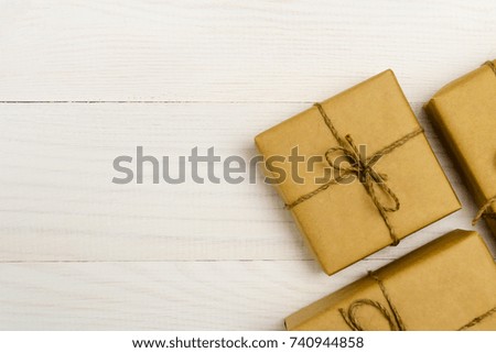 Presents in gift boxes package on white wooden table. Copy space.