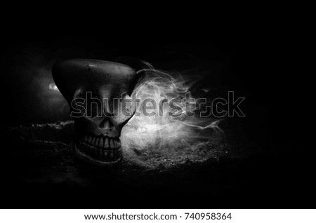 Scary skull on toned light dark background. Design for Halloween background or horror theme