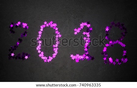 2018 figures on a black background purple sequins, the concept of the new year