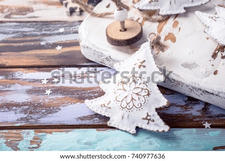 Metal white christmas tree with ornament on old wooden grunge background with copy space.