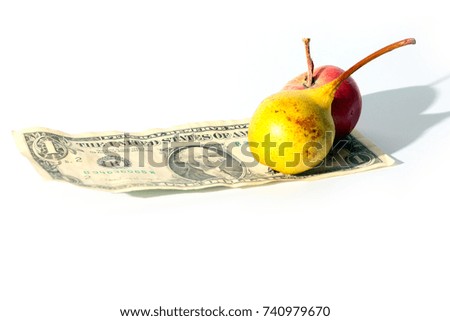 ripe apple and pear fruit on paper dollar bill