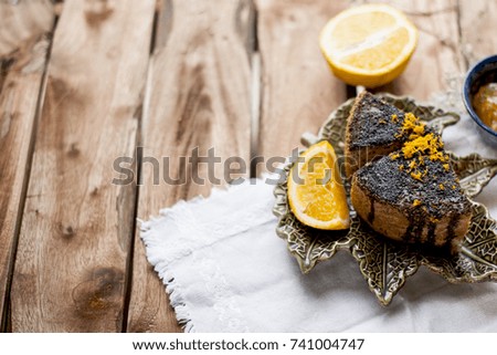 pie with poppy and orange for breakfast, on a wooden background