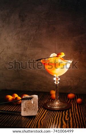 Red cocktail with little orange