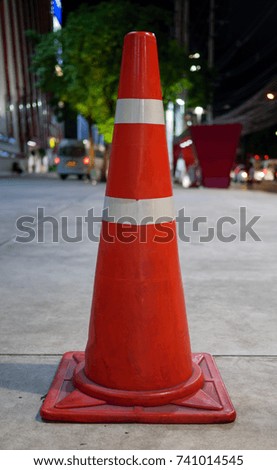 Orange traffic cone on blurred background