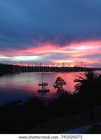Morning sunrise view across the water of Sydney harbour to Taronga Zoo from Cremorne Point.