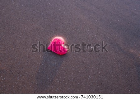 love symbol of heart on the sea beach