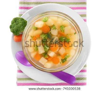Bowl of delicious baby soup on table