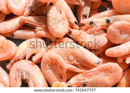Delicious frozen shrimps as background