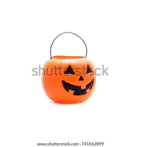 Studio shot Jack O' Lantern Halloween pumpkin pail isolated on white background. Orange plastic Trick Or Treat candy bucket made from resin.
