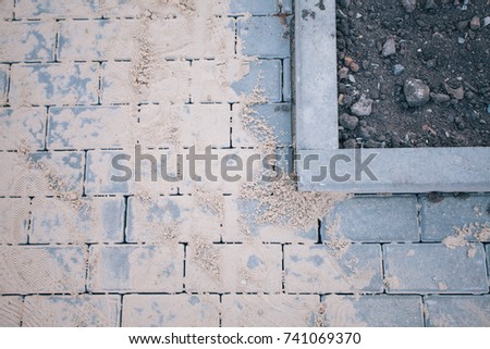 A large area, laid out of paving stone in perspective. Detailed photo of paving stones in the sidewalk avenue close-up