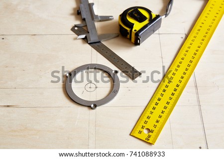DIY concept. Carpenter craft table. Woodworking shop. Woodworkers tools on a workbench in a workshop. The tools of the joiner. Accessories for router table. Measuring tool. Top view Plywood background