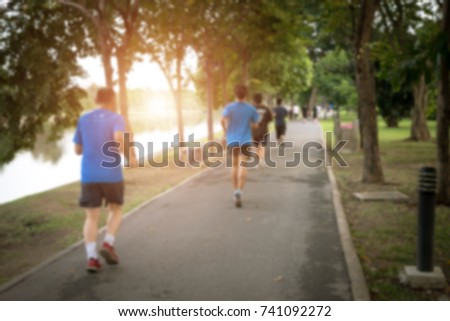 Blurry Picture of Asian Family are Running in Outdoor Public Park Background - Lifestyle Sport Recreation Concept